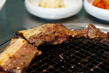 Korean BBQ with Raw Beef Short Ribs Grilled on Charcoal at Local Galbi Restaurant