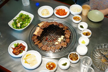 Korean BBQ with Raw Beef Short Ribs Grilled on Charcoal at Local Galbi Restaurant