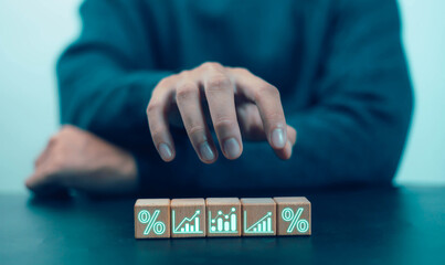 
Concept of rising wooden blocks with percentage symbol, up direction icon, high inflation concept,...