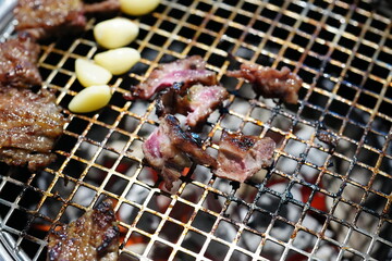 Korean BBQ with Raw Beef Short Ribs Grilled on Charcoal at Local Galbi Restaurant