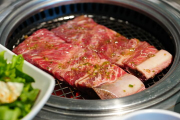 Korean BBQ with Raw Beef Short Ribs Grilled on Charcoal at Local Galbi Restaurant