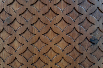 Unique geometric wood carving patterns with overlapping circles and diamond shapes.