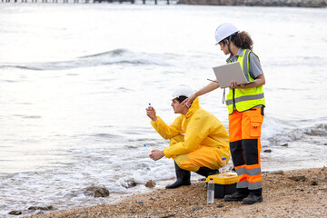 Researchers Testing Water Quality at a Lake or Coastal Area, Environmental Scientists Collecting Water Samples for Analysis, Water Pollution Control, Scientists at Work in the Field