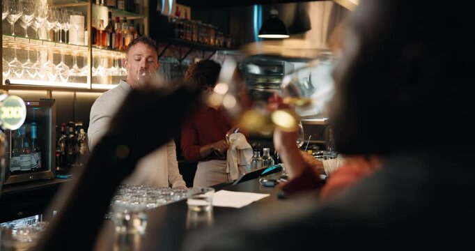 Drinking, wine and people in pub, smile and talk with friends for alcohol quality, critic and night. Sommelier, group and discussion for rating of taste, evening or happy with flavor of liquor in bar