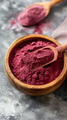 Close-up of natural red beetroot powder in a bowl with fresh beetroots, vibrant and organic food ingredient.