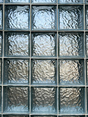 A partition made of glass blocks, also known as glass bricks, often have textured or patterned...