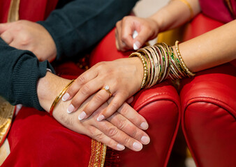 Close up of hands of a couple of man and woman. Photo of an Indian couple, woman touching man's...