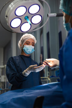 Nurse and doctor performing surgery in an operating room