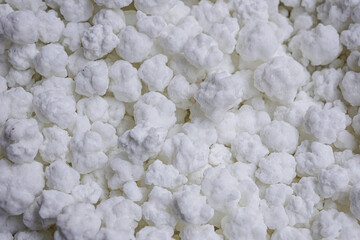 A close-up of asafoetida granules (Ferula assa-foetida) reveals their clustered, chalky...