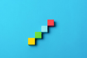 Abstract colorful blocks steps on blue background symbolizing progress, growth, business, education