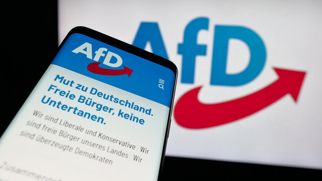 Stuttgart, Germany - 06-26-2025: Mobile phone with website of German Alternative f&uuml;r Deutschland (AfD) on screen in front of logo. Focus on top-left of phone display.