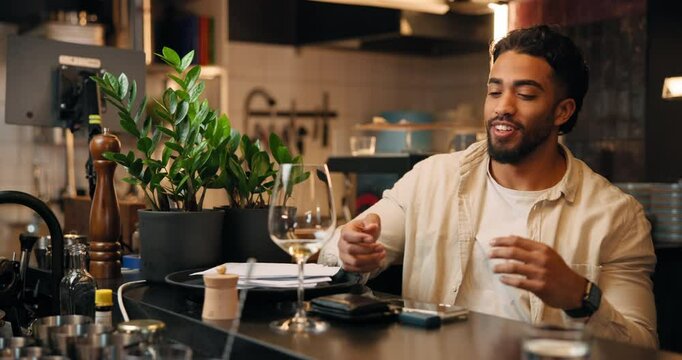 Man, barman and machine with watch payment, transaction and fintech at bar. Bartender, people and electronic pos with alcohol checkout, purchase drinks and contactless for customer experience at pub