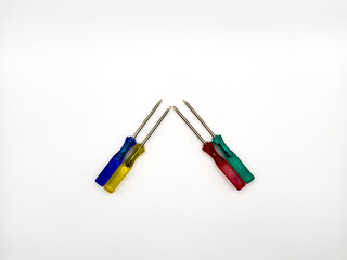 Fototapeta premium Four small colored plastic screwdrivers on a white background. copy space, flay lay, top view. High quality photo.