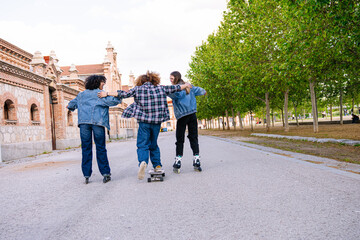 Obraz premium Group of young friends enjoying an afternoon skating and skateboarding together, symbolizing freedom, friendship, and urban lifestyle