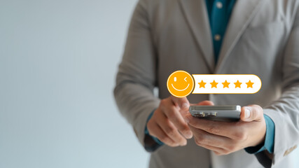 Customer feedback and satisfaction rating, businessperson using smartphone to give five-star...