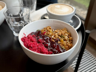 Baked Granola with Yogurt, Lingonberry Jam, and Raspberry Sorbet. Breakfast Out Concept. Handheld Phone Photo, Selective Focus, Sunlight, Non-AI
