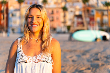 Smiling surfer enjoying slow living in villajoyosa, spain, at sunset