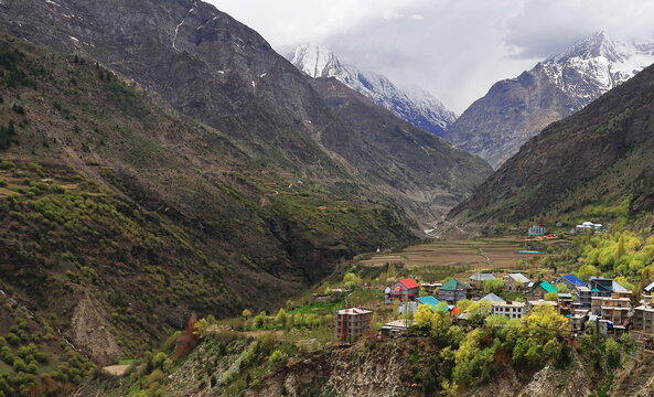 birds eye view of beautiful kyelang or keylong hillstation, surrounded by snowcapped himalaya mountains in lahaul valley, himachal pradesh in india