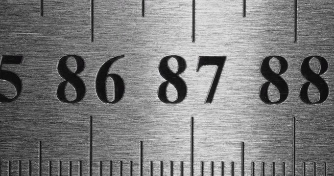 Metal Ruler Close-Up. Video featuring a detailed view of a sleek metal ruler with precise millimeter markings, captured in high clarity.