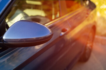 Part of a blue car in the sun rays