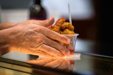 Take away stir fry food being served into a container by hand