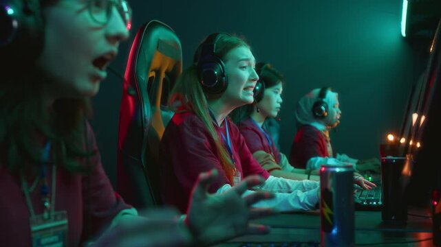 Medium close-up of team of cyber gamers talking anxiously while fighting enemies in online video game, then getting defeated and reacting with dismay. Perfect for PC gaming and cyber sport marketing