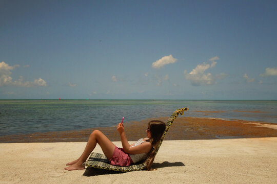 Profile tween girl on cell phone beautiful beach Florida Keys re
