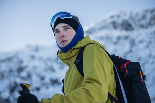 Ski tourer in Kitzb&uuml;hel Alps with backpack and goggles