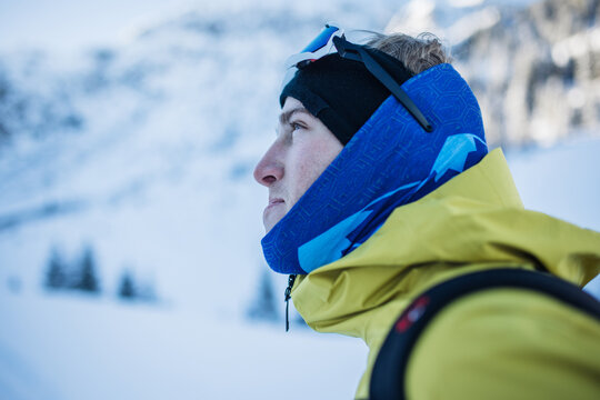 Man in ski gear looking ahead in snowy Kitzb&uuml;hel Alps