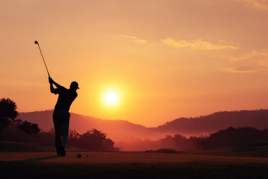 Golfer hit sweeping driver after hitting golf ball down the fairway with sunrise background