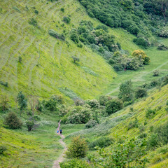 people jogging in The Devil's Kneading Trough which is part of kent downs on summer day early june