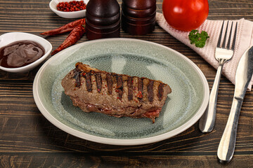 Grilled beef striploin steak with sauce