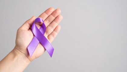 Hand holding purple awareness ribbon. Pancreatic cancer, Alzheimer disease, epilepsy