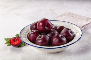 Raw ripe purple plum heap