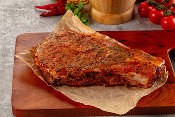 Raw marinated pork loin steak