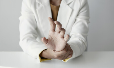 Woman hand with wrist pain numbness and pain in the palm of the hand has pain and tingling in the nerve endings This is a side effect of sitting and working for a long time on a laptop at the office