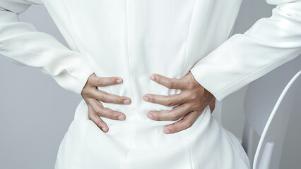 Woman having back body pain during work long time. stretching to relax and relax while working hard...