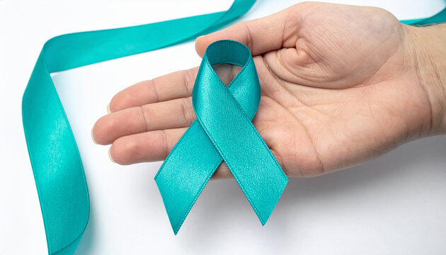 Hand holding teal awareness ribbon. Ovarian Cancer Awareness. Sexual Assault Awareness