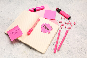 Sticky notes with word DONE, text DON'T FORGET and stationery on grunge background