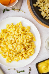 Plate of tasty Italian pasta with Cheddar cheese on light background