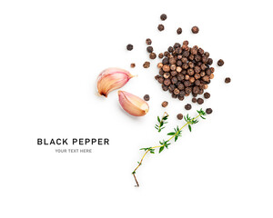 Black peppercorns heap with garlic cloves and green thyme photography isolated on white background