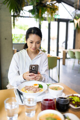 Woman take photo of meal for social media