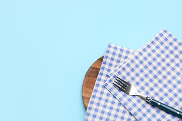 Clean napkins and fork on color background