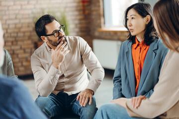 Group of professionals sharing ideas during brainstorming session in office