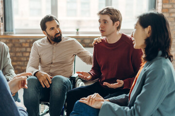 Diverse group of multinational people supporting each other during group therapy session