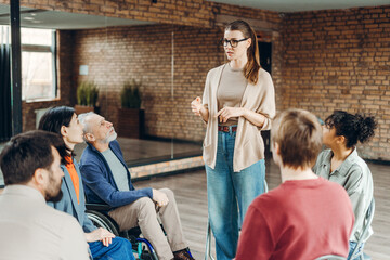 Young, beautiful woman, coach leading a support group meeting for people