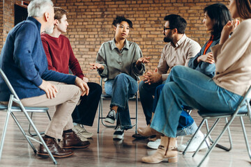 Group of diverse patients discussing problems during group therapy session