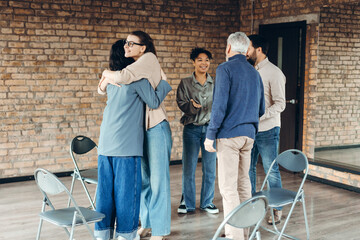 Team members are hugging and supporting each other during therapy session