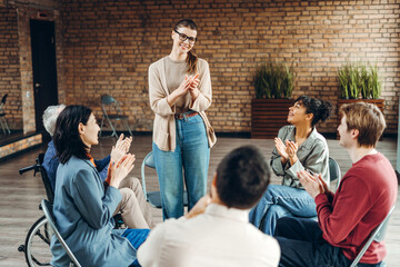 Diverse team clapping for coach after successful training session
