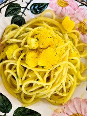 evocative close-up image of a homemade spaghetti with potatoes, saffron and parsley
